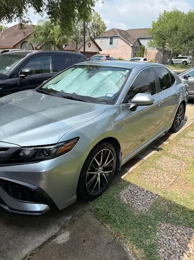 Freshly detailed silver Toyota Camry parked in a residential driveway, Brownsville TX